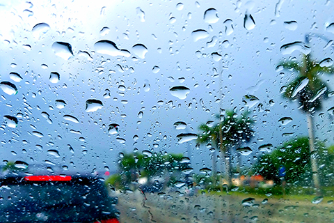 A stock photo. Raindrops on a car window during a storm.