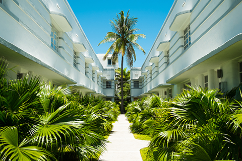 A stock photo. The courtyard of an apartment community in the art deco district of Miami Beach, Florida.