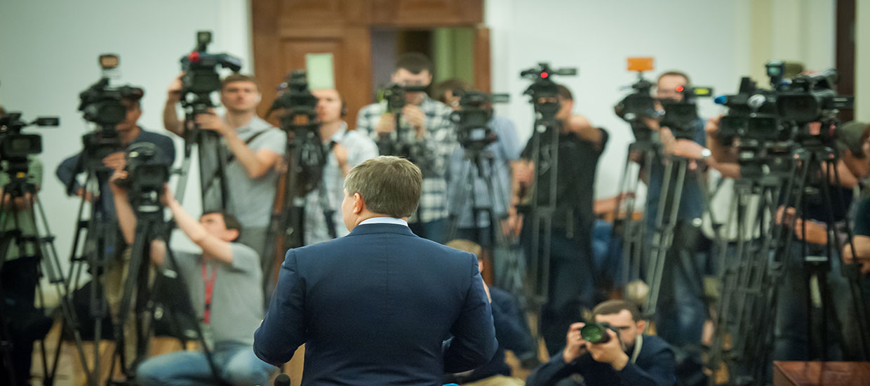 This is a stock photo. A man speaking at a press conference.