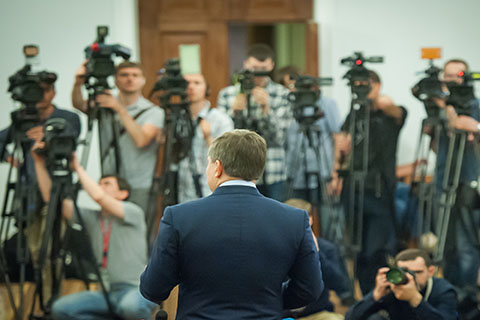 This is a stock photo. A man speaking at a press conference.